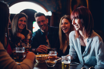 Group of teens having fun in a pub