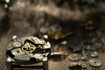 Mechanical watch assembly, watchmaker's workshop with many parts and gears