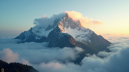 Obraz premium A towering misty mountain peak emerging above dense clouds, bathed in golden sunlight, its rugged slopes glowing as morning light breaks through.