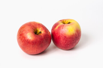 Two ripe red apples on a white background. Isolated