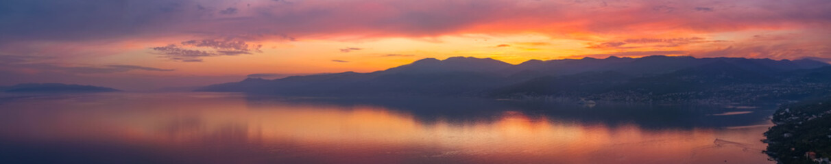 Panorama of a beautiful pink sunset reflected in the sea
