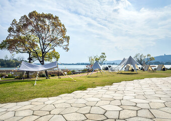 Tranquil Outdoor Camping Scene by the Lake with Tents and Scenic Views