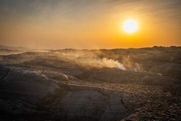 Sun setting on volcanic fumes in Erta Ale volcano in Afar region, Ethiopia