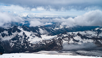 snowy mountain peaks in the clouds