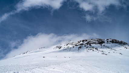 snowy mountain peaks in the clouds