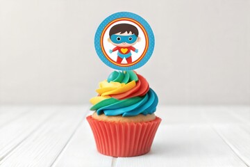 Celebration cupcake with superhero-themed birthday topper