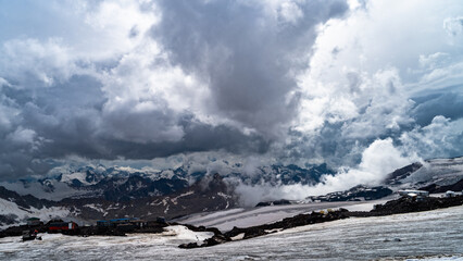 snowy mountain peaks in the clouds