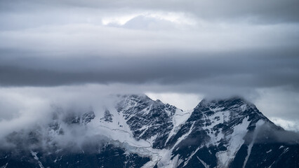 Obraz premium snowy mountain peaks in the clouds