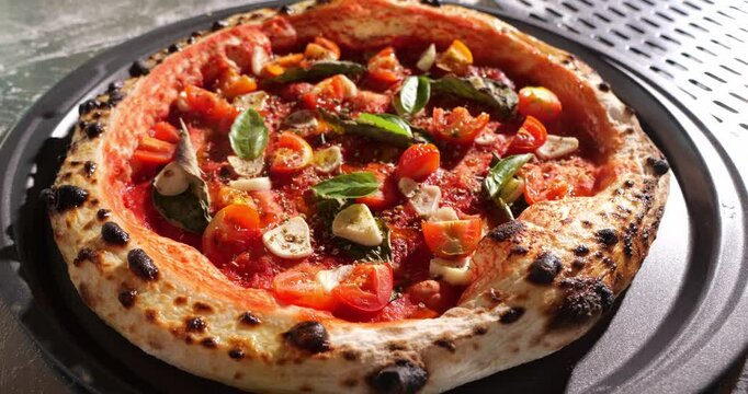 Marinara pizza with tomato sauce, tomatoes, basil, garlic, oregano and olive oil. Neapolitan style pizza