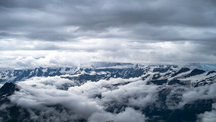 snowy mountain peaks in the clouds
