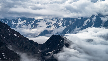 snowy mountain peaks in the clouds