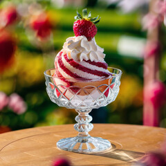 Strawberry dessert with whipped cream in crystal bowl