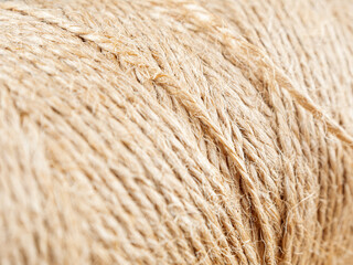 A close-up of a finely woven rope. The intricate texture and detail of the weave are clearly visible.
