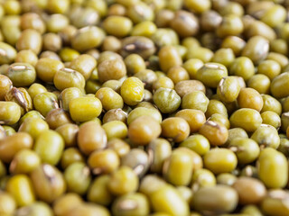 Mung beans on a light background, emphasizing their shape and texture, create a feeling of freshness and naturalness.