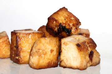 Tasty Cubes Chunks of Tofu Soy Pieces Vegan Fried Golden Cooked Close up on White Background
