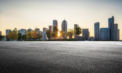 Sunset Over City Skyline with Trees and Open Space