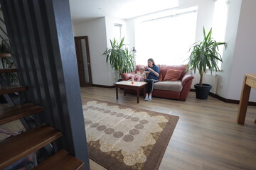 Mother and a child girl cooking and eating indoors together 