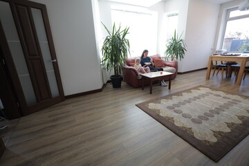 Mother and a child girl cooking and eating indoors together 