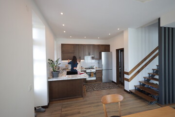 Mother and a child girl cooking and eating indoors together 