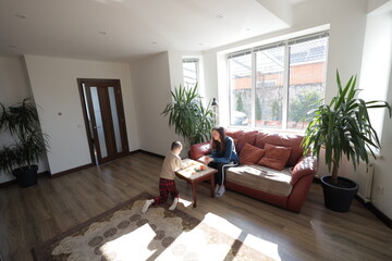 Mother and a boy child play together indoors