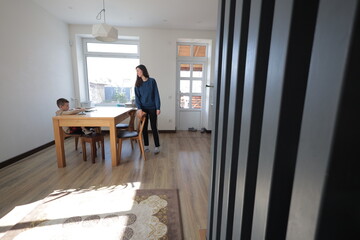 Mother and a boy child play together indoors