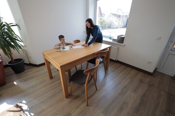 Mother and a boy child play together indoors