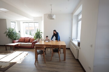 Mother and a boy child play together indoors
