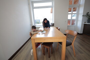 Mother and a boy child play together indoors