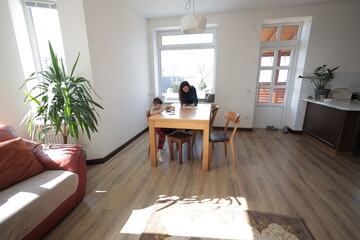 Mother and a boy child play together indoors