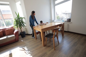 Mother and a boy child play together indoors