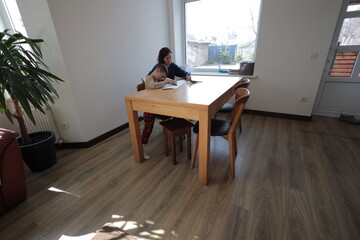 Mother and a boy child play together indoors