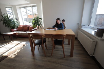 Mother and a boy child play together indoors