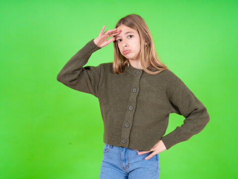 beautiful caucasian girl wearing striped sweater having problems, worried and stressed holds hand on forehead.