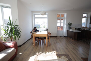 Mother and a boy child play together indoors