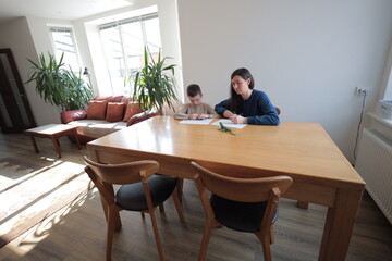 Mother and a boy child play together indoors