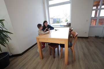 Mother and a boy child play together indoors