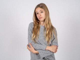 beautiful caucasian girl wearing grey track-suit shaking and freezing for winter cold with sad and...
