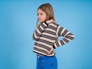 beautiful caucasian girl wearing striped sweater got back pain