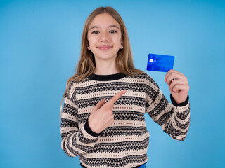 Photo portrait of beautiful caucasian girl wearing striped sweater doing purchase with pointing...