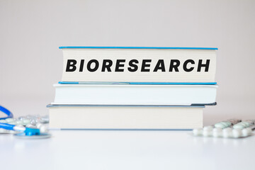 Obraz premium Bioresearch inscription medical scientific books background