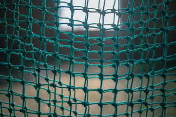 green mesh close up selective focus background image, indoor baseball game facility 
