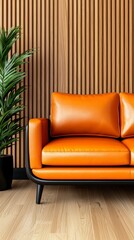 Fototapeta premium Cozy living room interior featuring a stylish leather sofa and lush green plant against a modern wall mockup