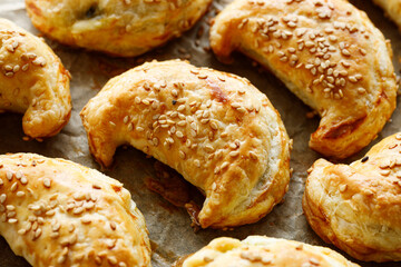 Puff pastry crescents stuffed with vegetarian filling, close-up

