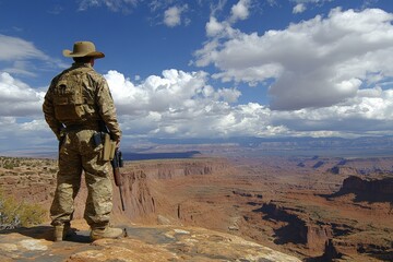 Soldier surveying a vast canyon landscape under a dramatic sky near a desert area