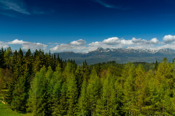 The most famous Slovak peak in the High Tatras - Krivan. A view of the Cierny Vah hydroelectric power plant. High Tatras scenery. Monumental peaks over water level.