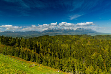 The most famous Slovak peak in the High Tatras - Krivan. A view of the Cierny Vah hydroelectric power plant. High Tatras scenery. Monumental peaks over water level.