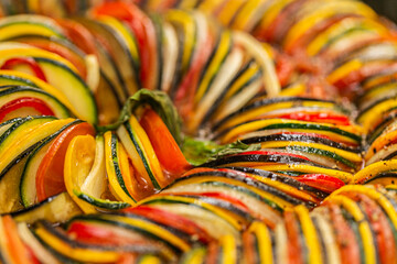 Chef preparing traditional Provençal vegetable dish Ratatouille with stuffed rolled meat on the...