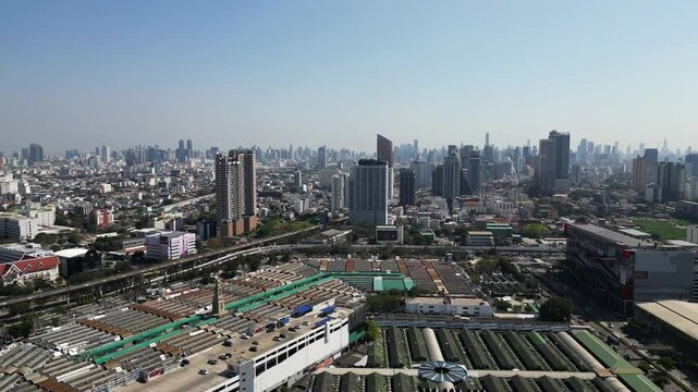 Aerial footage of Bangkok's stunning cityscape, showcasing Chatuchak Weekend Market under blue sky