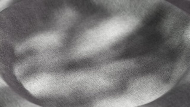 Soft gray textile surface dynamically transforming into concave shape, casting fluid shadows across material, creating elegant abstract movement with subtle visual depth