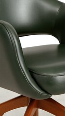 Obraz premium Elegant green armchair with wooden base displayed in a modern interior setting highlighting comfort and style
